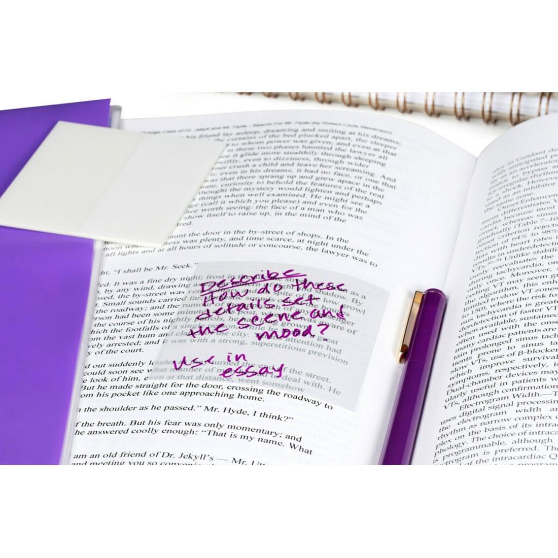 Transparent Post-It Note shown with purple pen on white paper