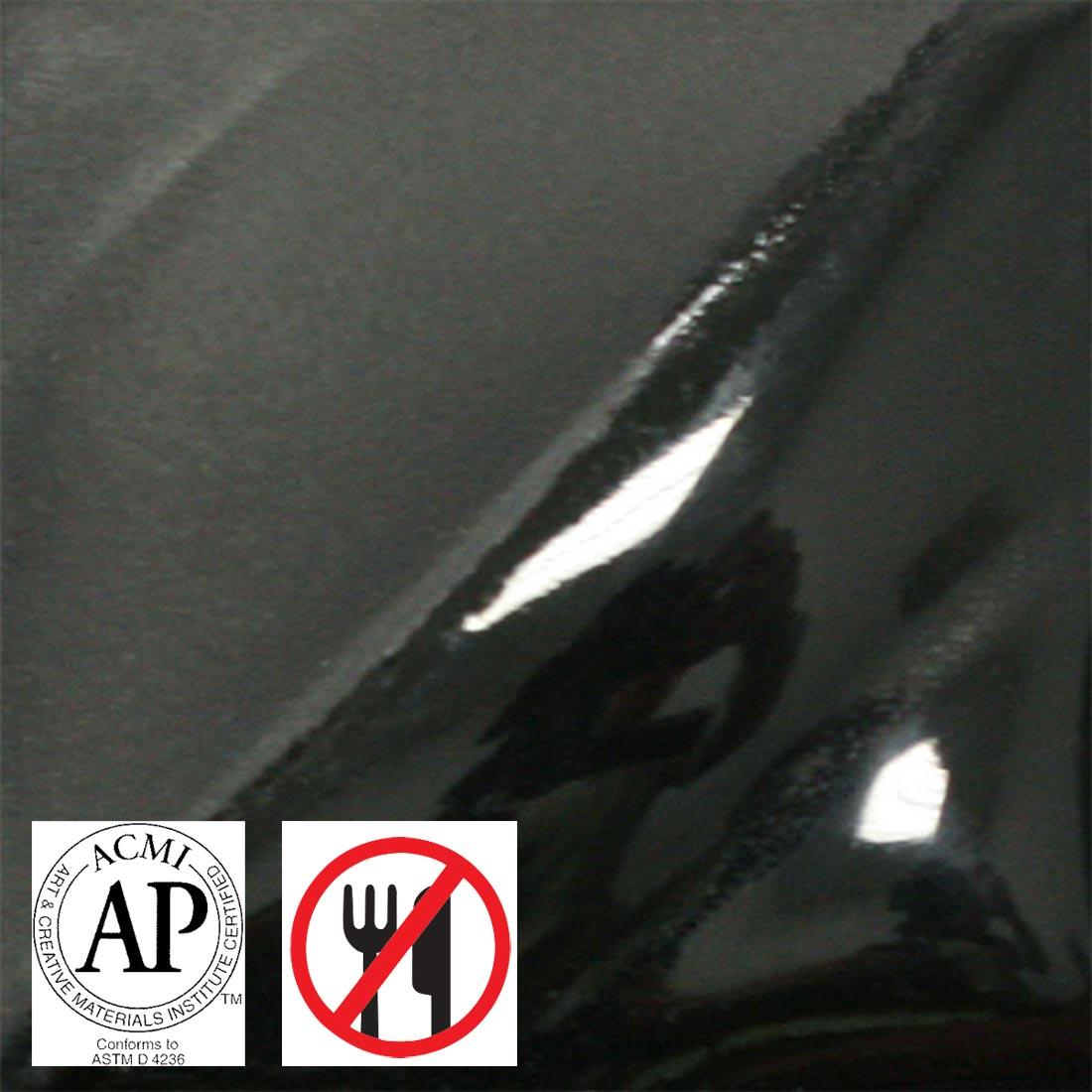 tile chip with black AMACO Velvet Underglaze applied; symbols for AP Seal and not food safe