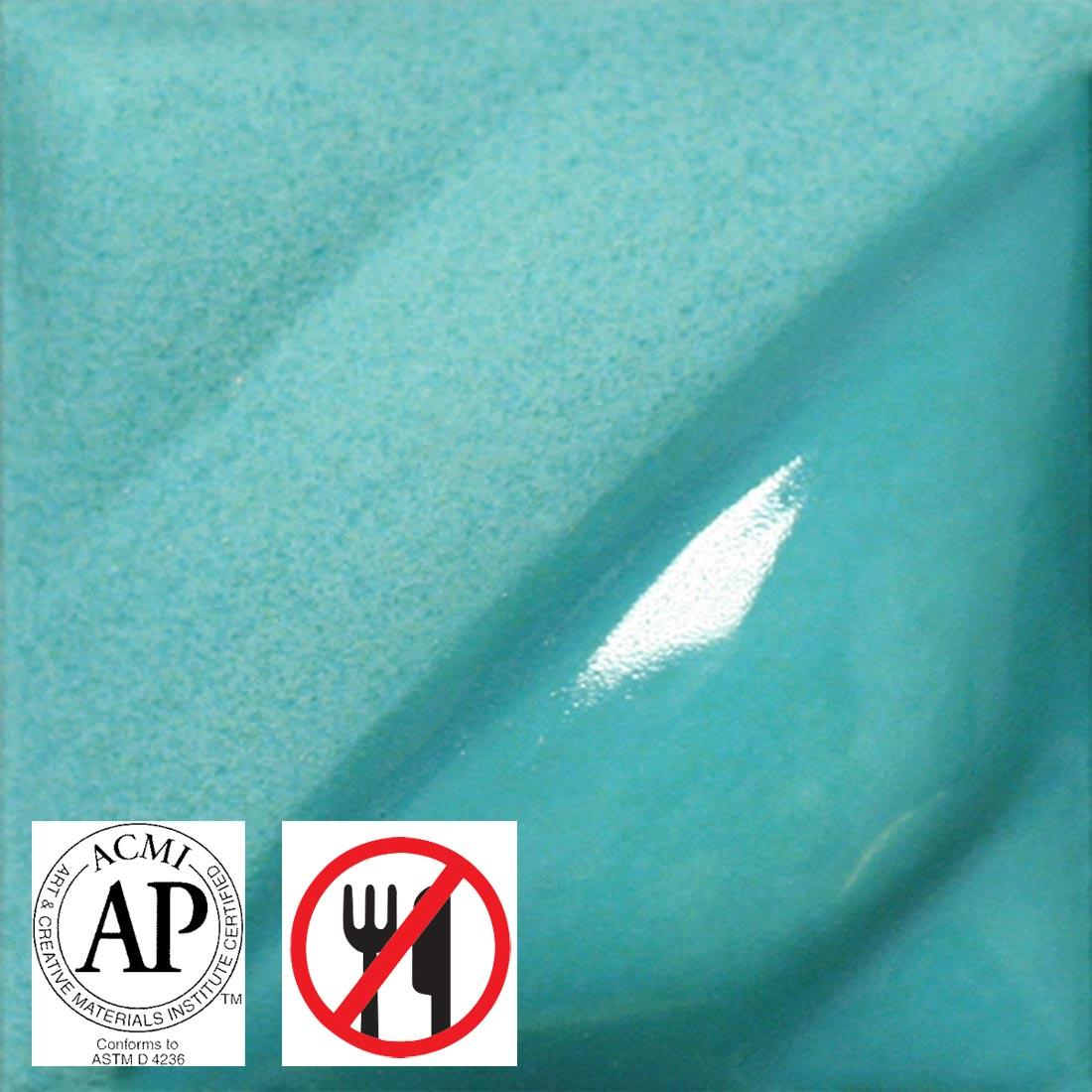 clay tile with Turquoise AMACO Velvet Underglaze applied; symbols for AP Seal and not food safe