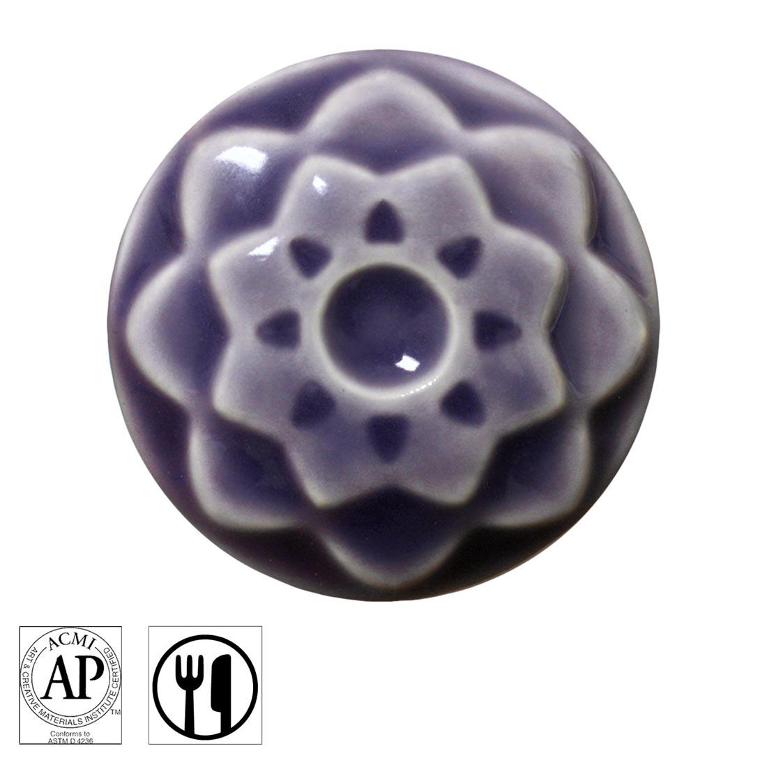 clay chip with Lavender AMACO Celadon High Fire Transparent Gloss Glaze applied; symbols for AP Seal and food safe