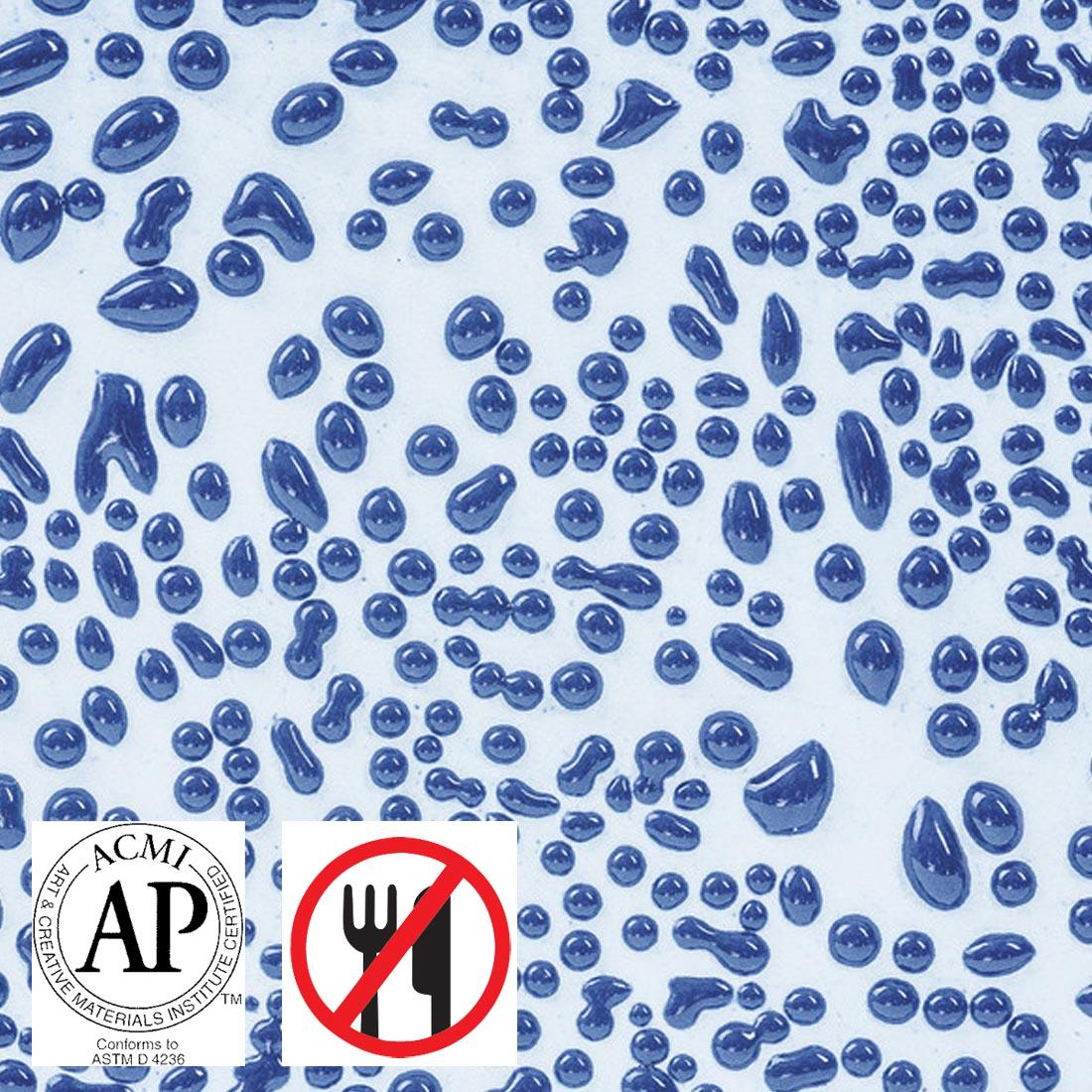 Clay tile with Dark Blue AMACO Crawls High Fire Glaze applied plus symbols for AP Seal and not food safe