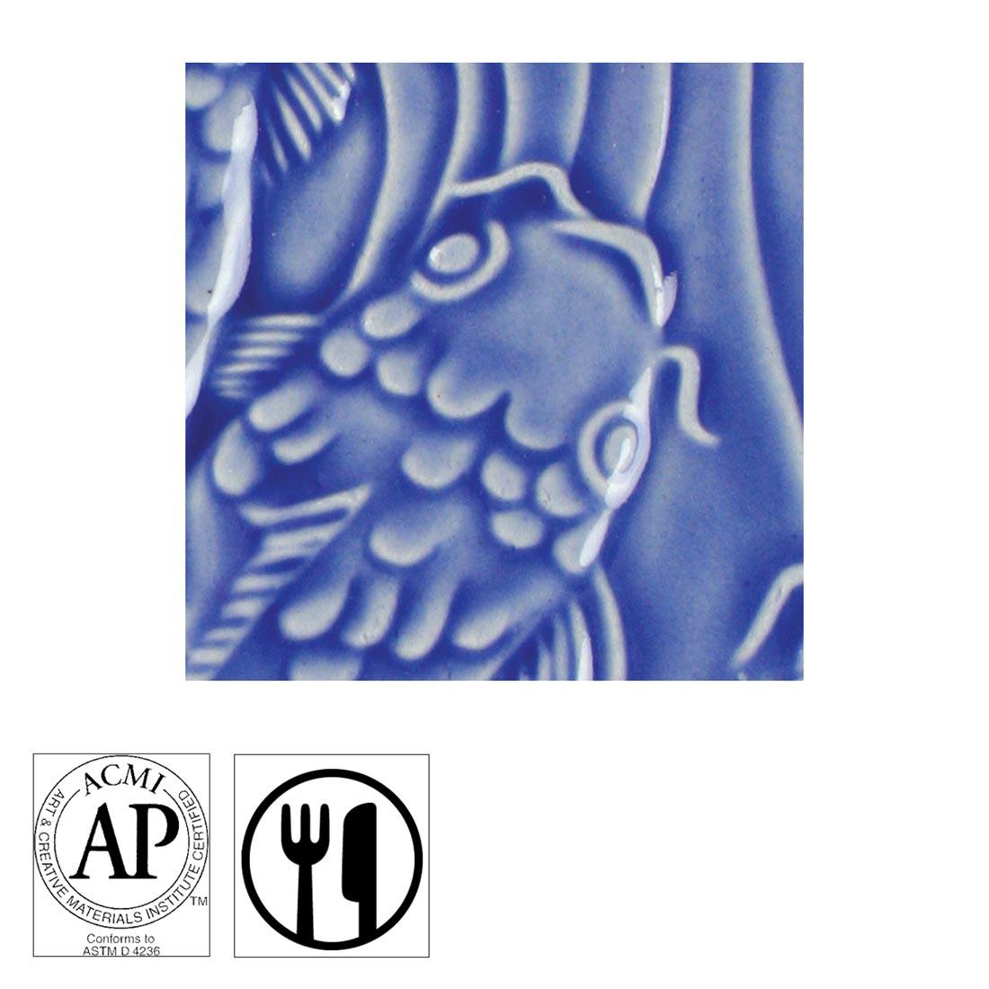 clay tile with Medium Blue AMACO Gloss Glaze applied; symbols for AP Seal and food safe