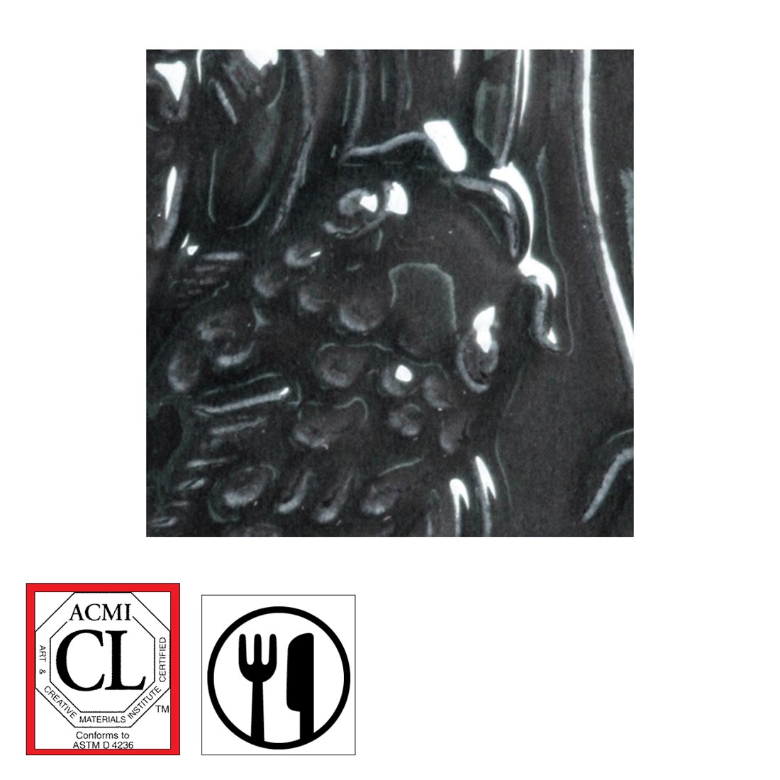 clay tile with Black Lustre AMACO Gloss Glaze applied; symbols for Cautionary Label and food safe