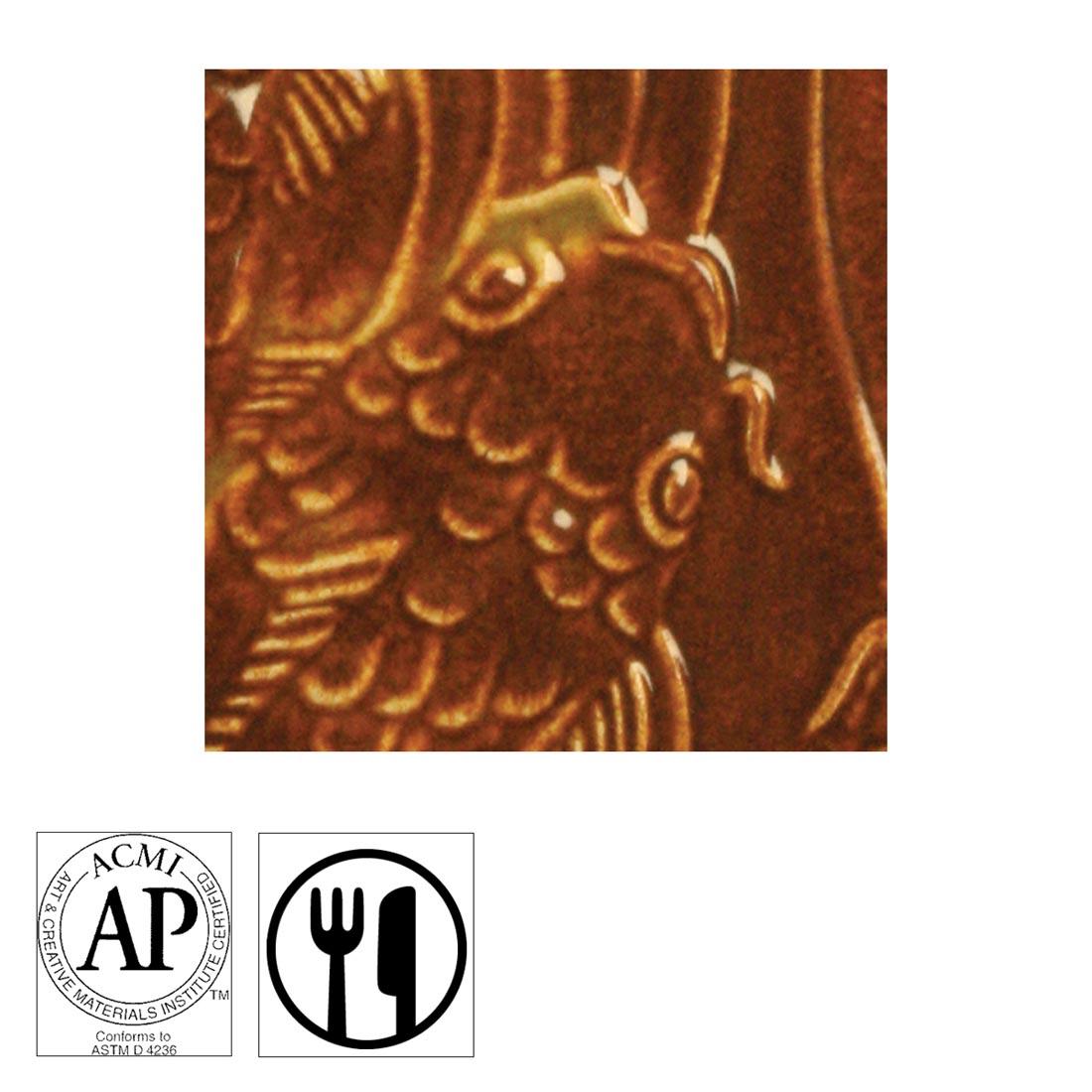 clay tile with Freckled Brown AMACO Gloss Glaze applied; symbols for AP Seal and food safe
