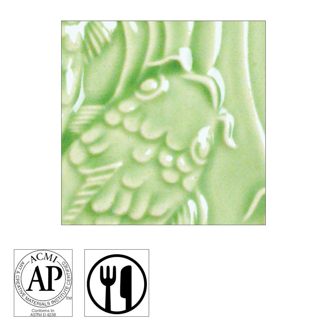 clay tile with Emerald Green AMACO Gloss Glaze applied; symbols for Cautionary Label and food safe