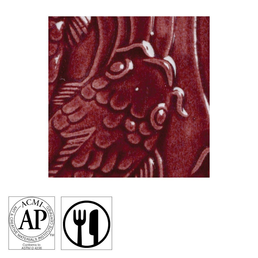clay tile with Maroon AMACO Gloss Glaze applied; symbols for AP Seal and food safe