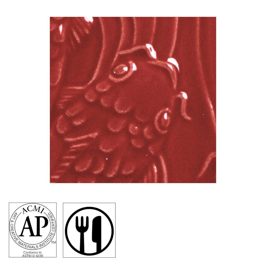 clay tile with Intense Red AMACO Gloss Glaze applied; symbols for AP Seal and food safe