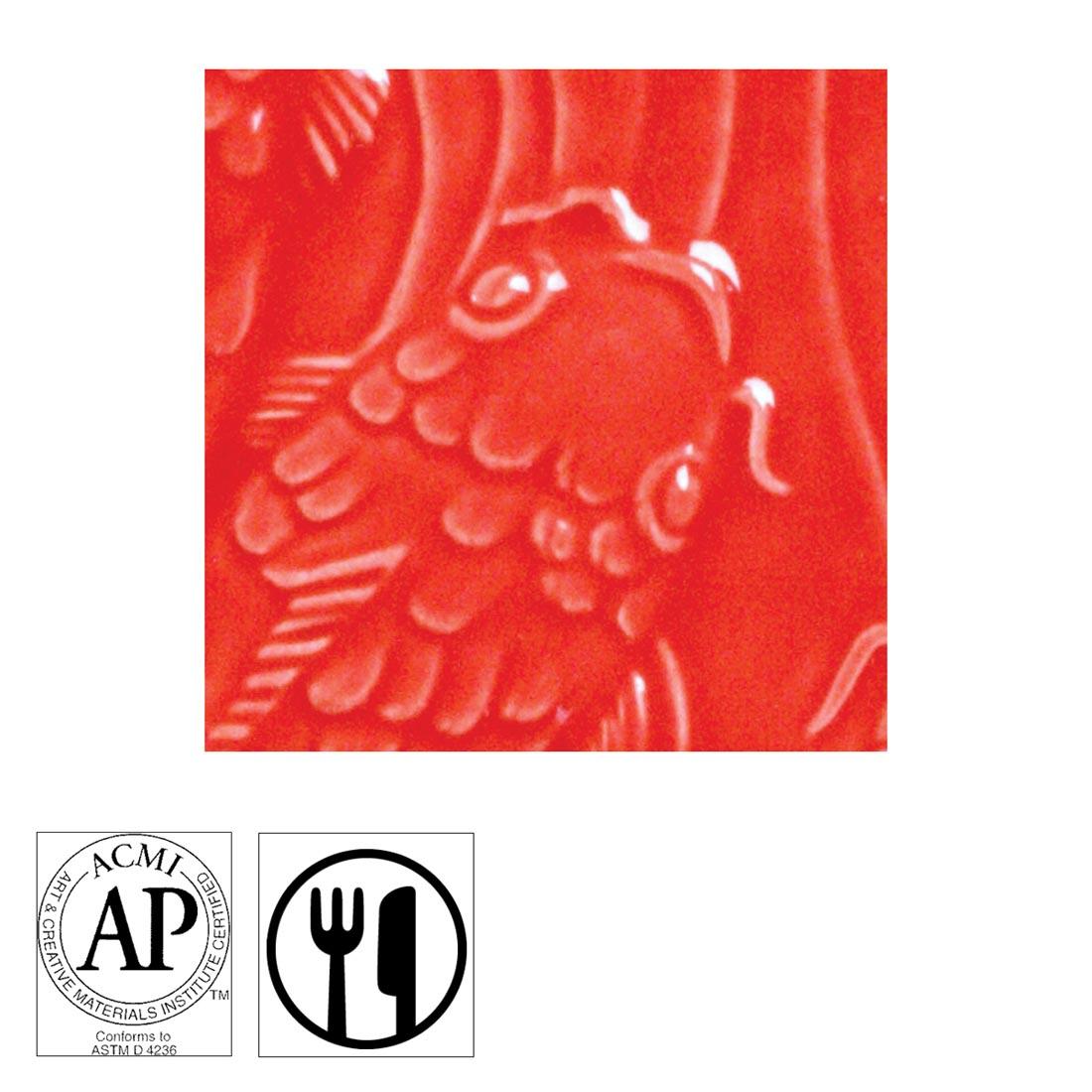 clay tile with Hot Red AMACO Gloss Glaze applied; symbols for AP Seal and food safe