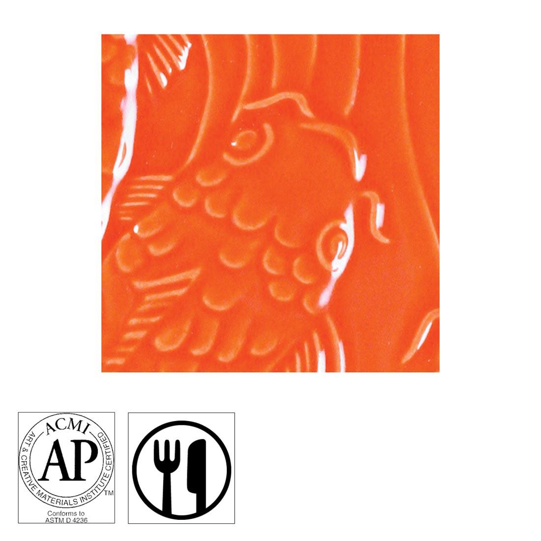 clay tile with Fire Orange AMACO Gloss Glaze applied; symbols for AP Seal and food safe