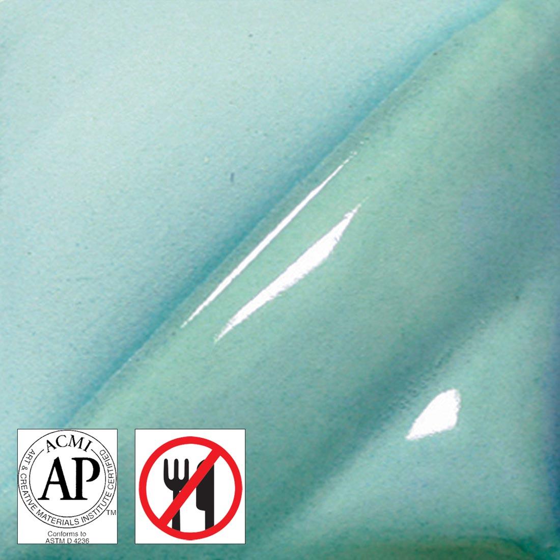 clay tile with Aqua AMACO Liquid Underglaze Decorating Color applied; symbols for AP Seal and not food safe