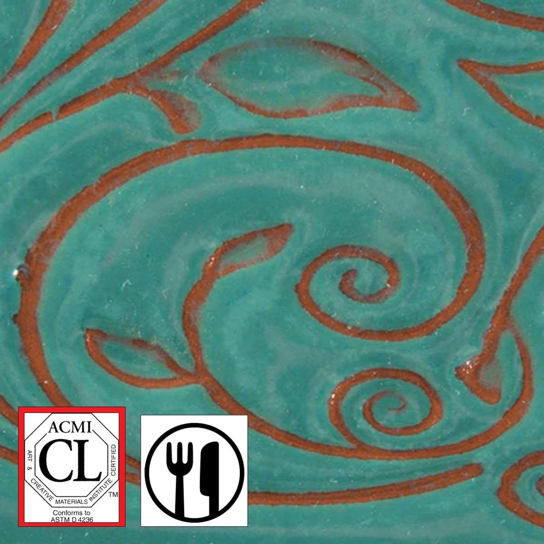 clay tile with Aquamarine AMACO Opalescent Glaze applied; symbols for Cautionary Label and food safe