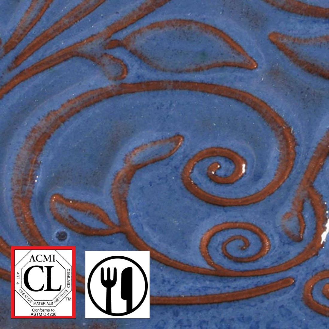 clay tile with Sapphire Blue AMACO Opalescent Glaze applied; symbols for Cautionary Label and food safe