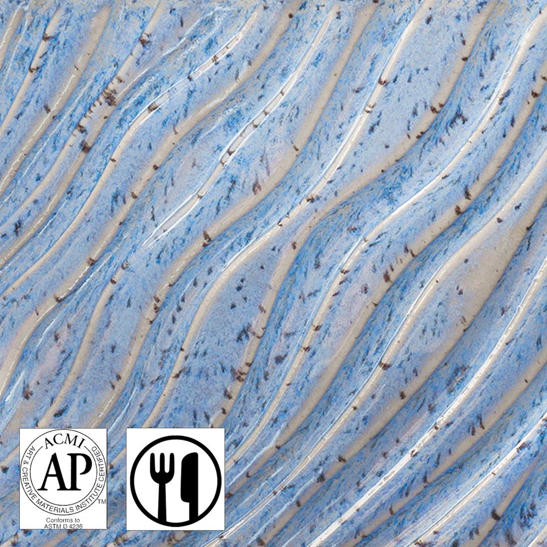 Clay tile with Ocean Drift AMACO Potter's Choice Flux High Fire Glaze applied plus symbols for AP Seal and Food Safe
