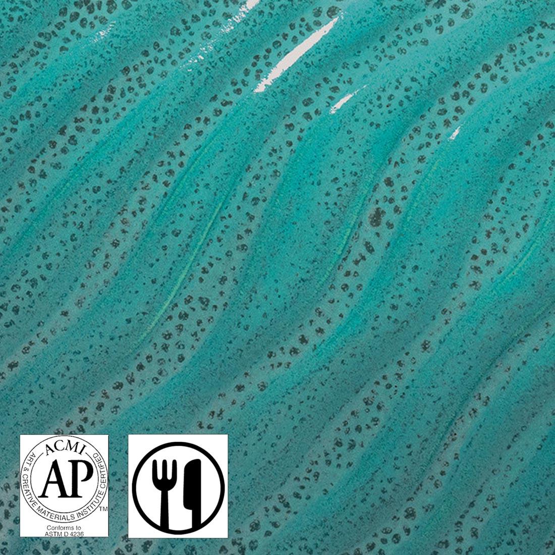 Clay tile with Teal Drift AMACO Phase High Fire Glaze applied plus symbols for AP Seal and Food Safe