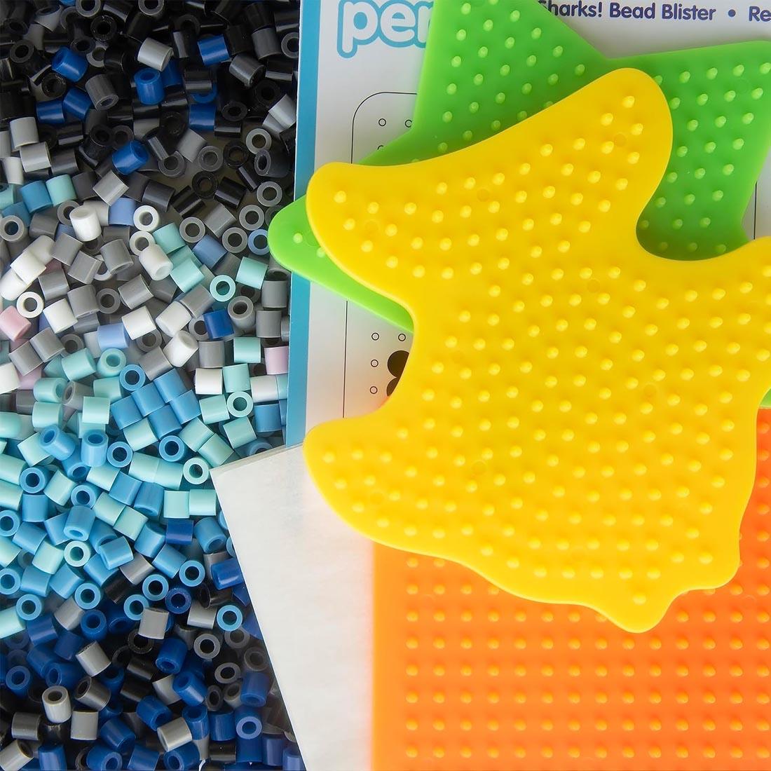 Contents of Perler Beads Sharks Activity Kit, showing various perler beads and 3 pegboards