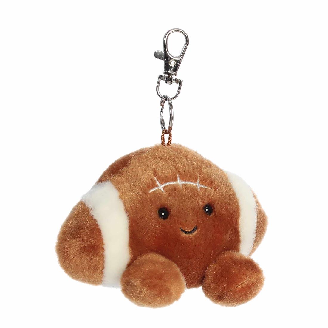 3/4 profile view of Aurora Plush Tackle Football Palm Pal Clip-On