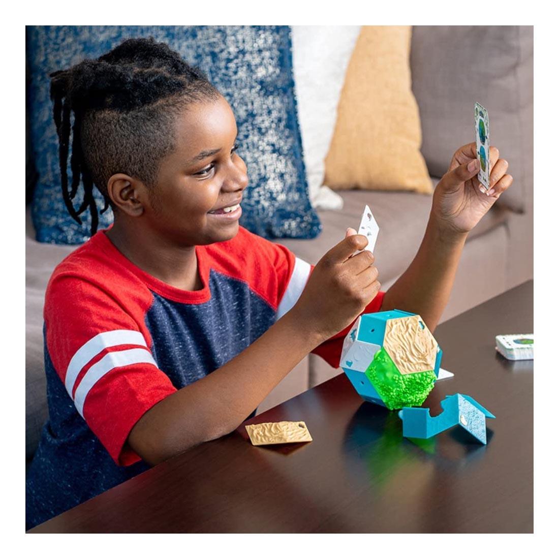 Child playing with the GeoLogic Puzzle By Thinkfun