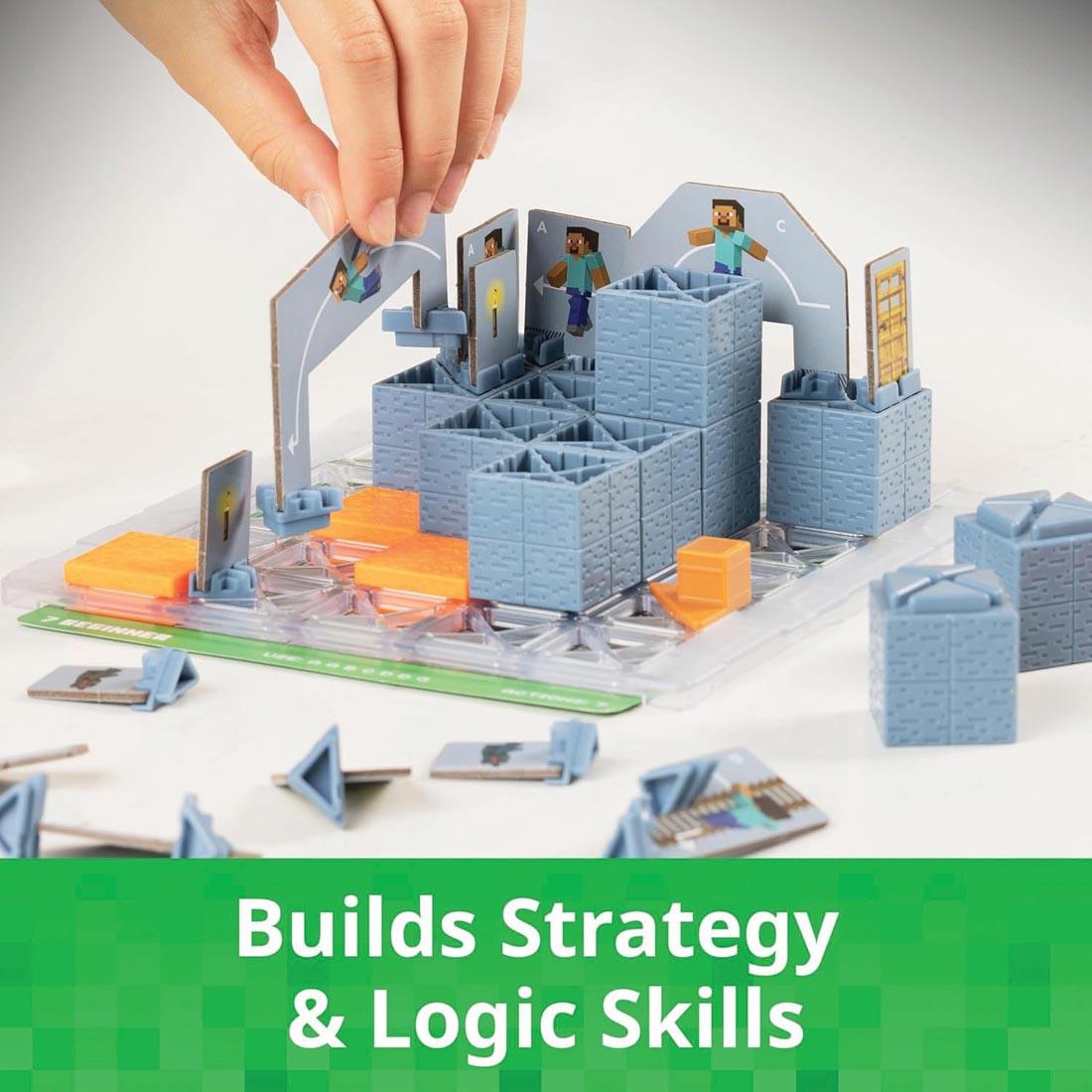 hands building the Minecraft Cave Adventure Game By ThinkFun plus text Builds strategy & logic skills