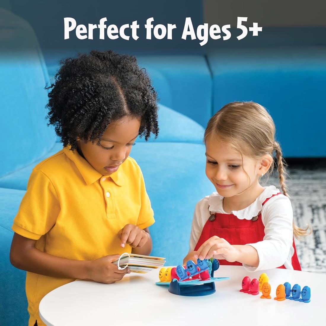 2 kids playing the Balance Beans Game By ThinkFun plus text Perfect for Ages 5+