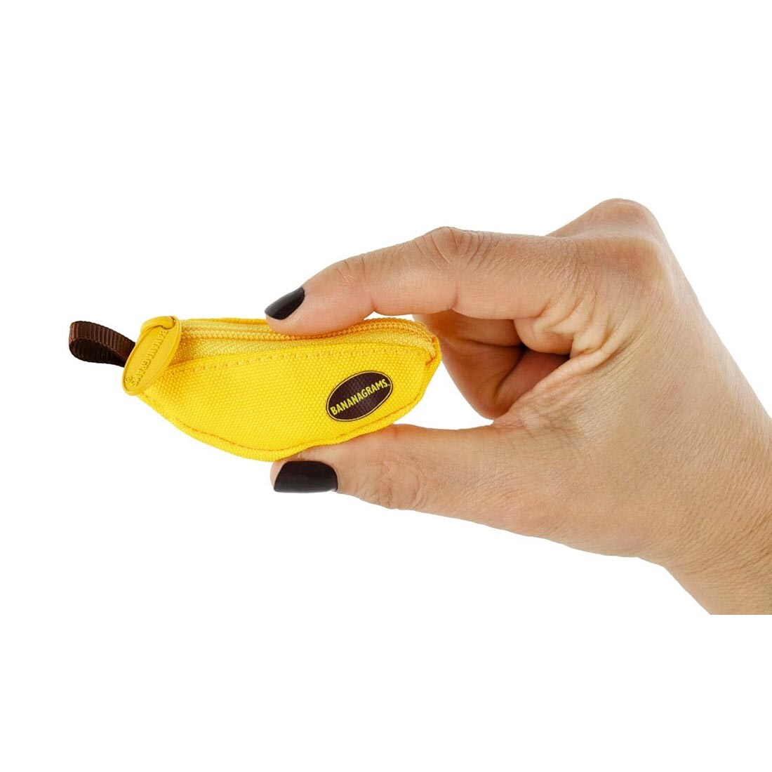 hand holding the World's Smallest Bananagrams Game between thumb and index finger