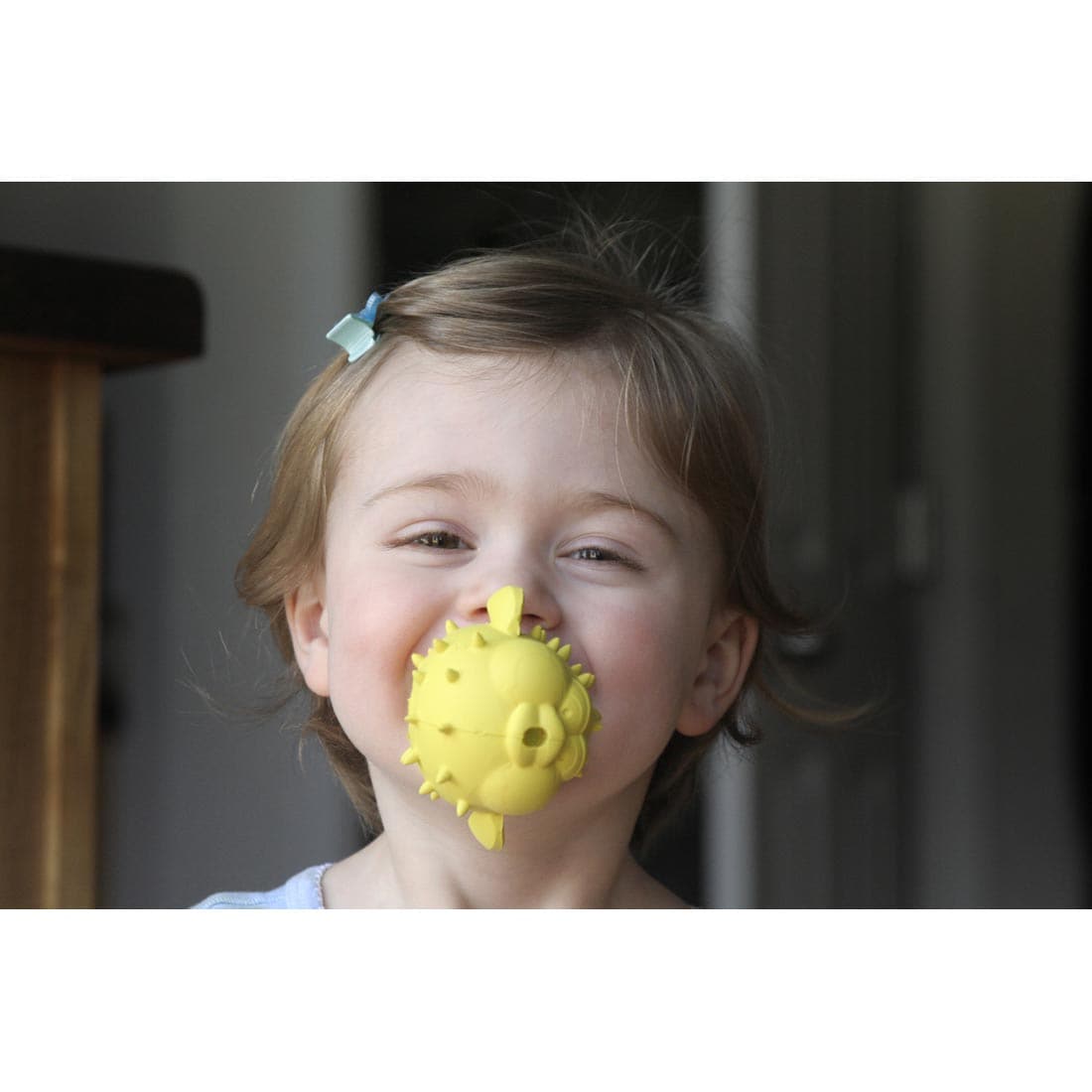 Child with Puffer Fish Bathtub Pal in their mouth