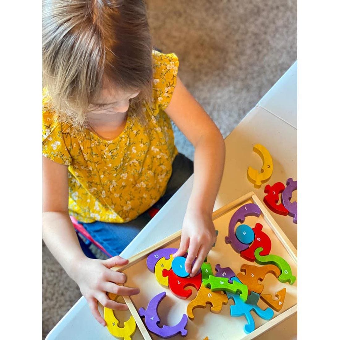 Child Putting Together the Butterfly A To Z Puzzle by BeginAgain Toys