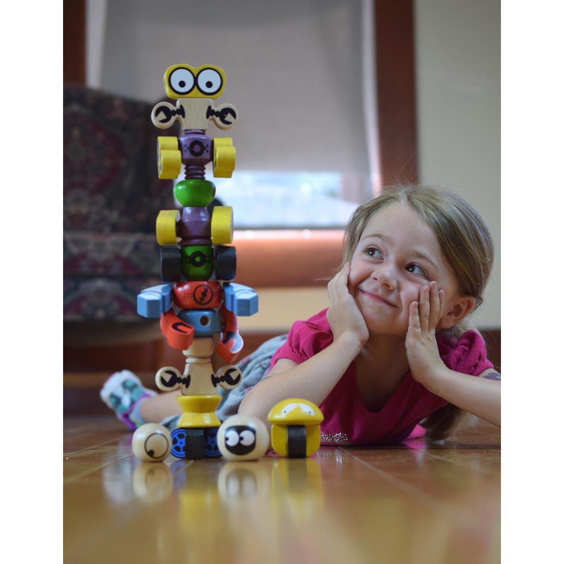 child looking at Tinker Totter Robot Character Set by BeginAgain Toys