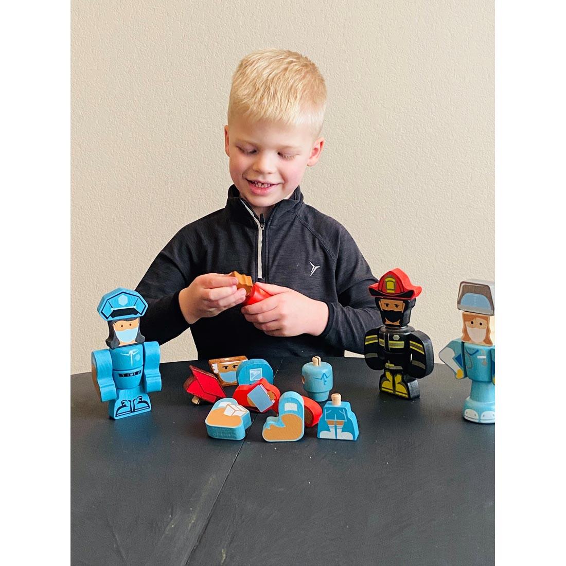 child playing with Tinker Totter Heroes Character Set by BeginAgain Toys