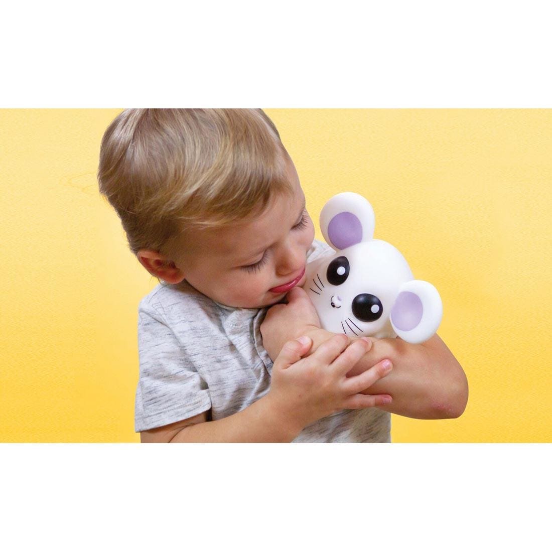 Child hugging the Where's Squeaky? mouse toy