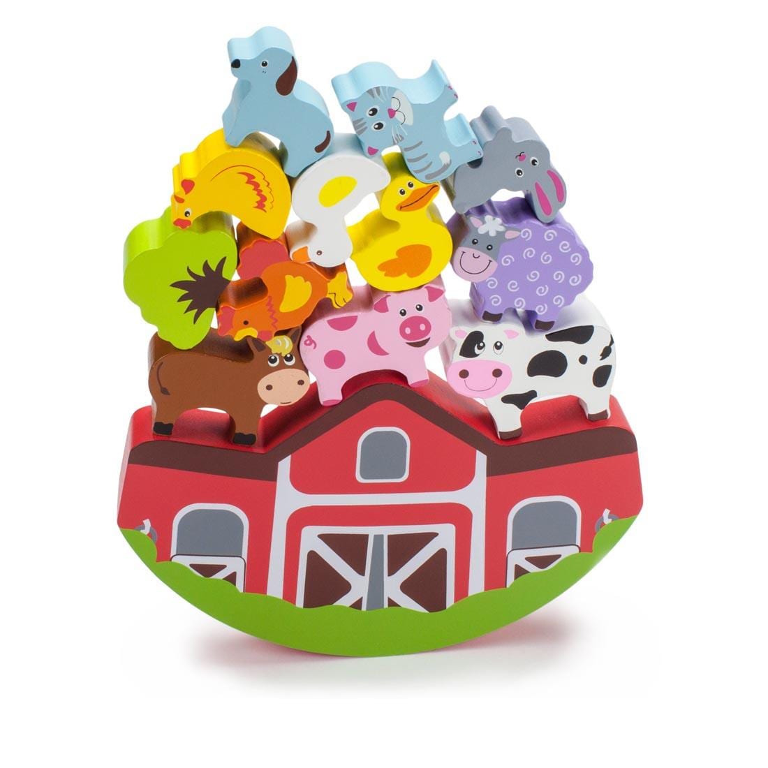 Wooden Barn with Wooden Animal Pieces Piled Up and Balanced