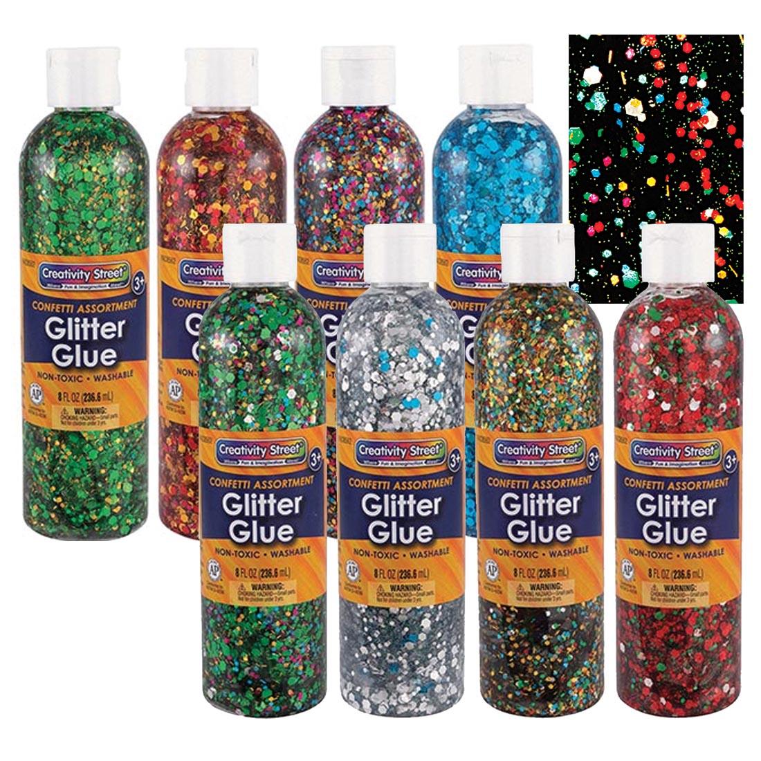 8 bottles of Creativity Street Glitter Chip Glitter Glue with a samples on a black swatch