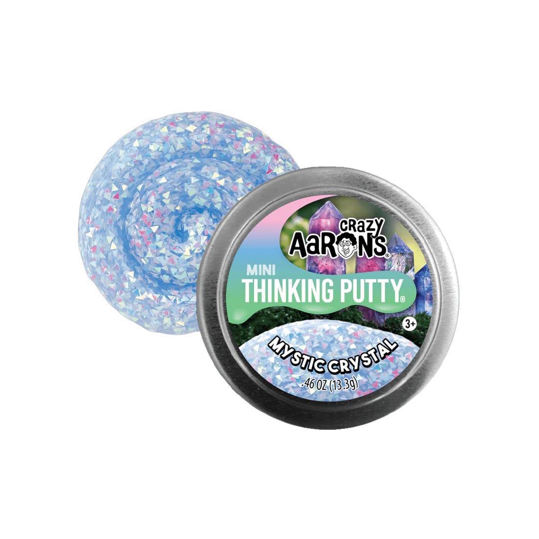 front of tin beside the Mystic Crystal Mini Thinking Putty by Crazy Aaron