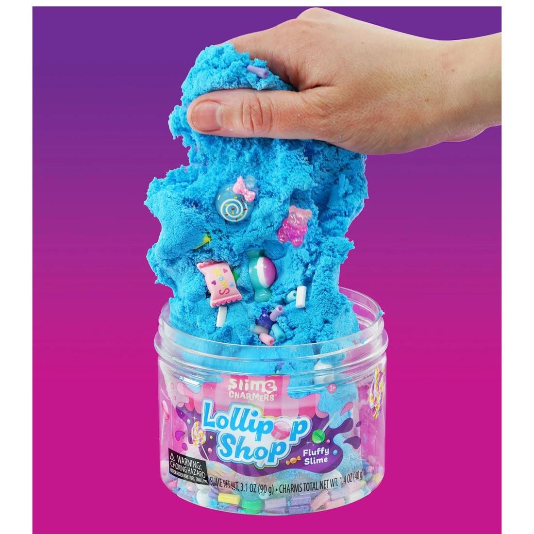 hand holding up slime full of charms from Lollipop Shop Slime Charmers By Crazy Aaron