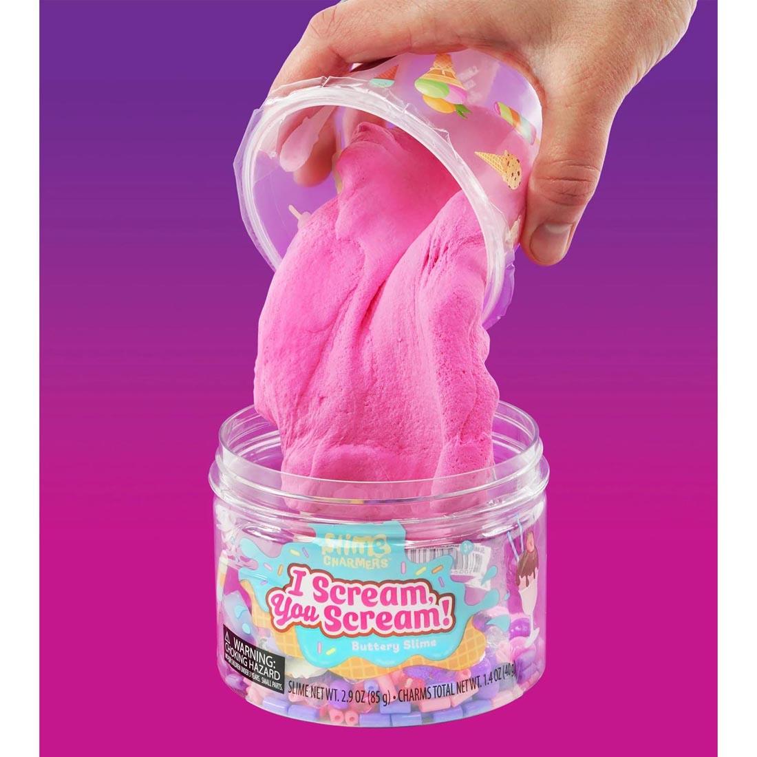 hand pouring the slime into the main container of I Scream You Scream Slime Charmers By Crazy Aaron