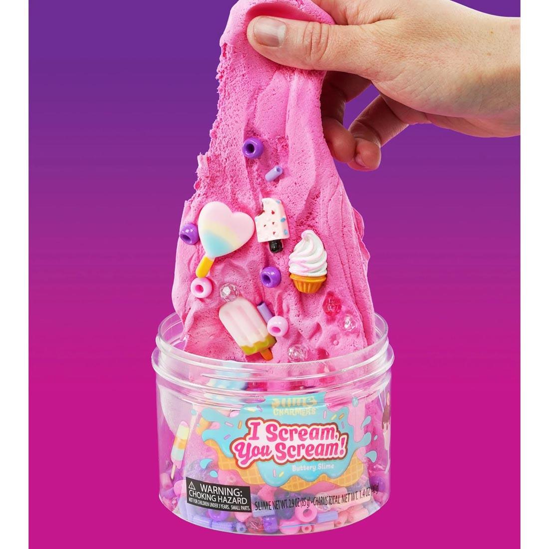 hand holding up slime full of charms from I Scream You Scream Slime Charmers By Crazy Aaron
