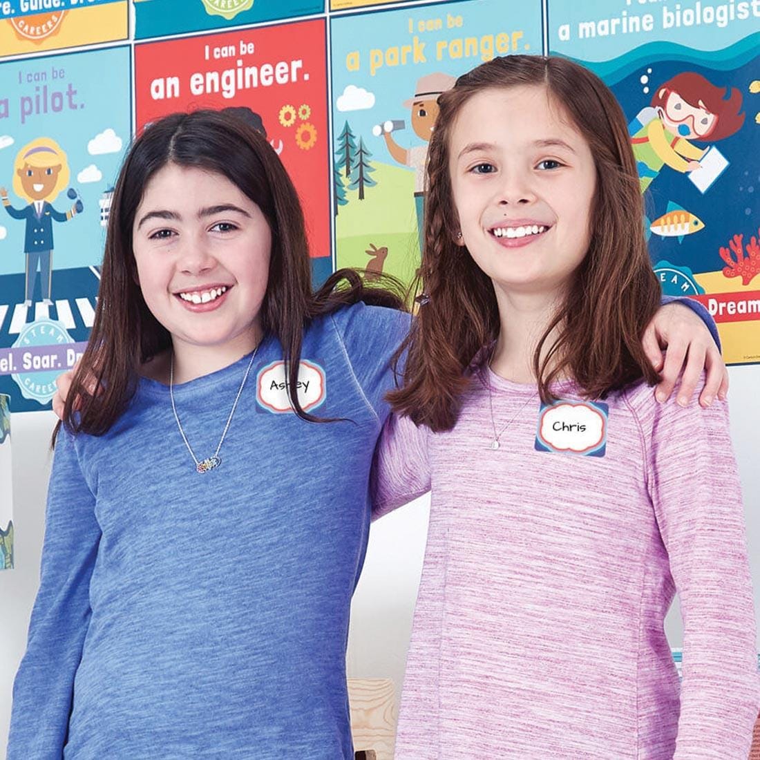 two kids wearing Name Tags from the We Stick Together collection by Carson Dellosa