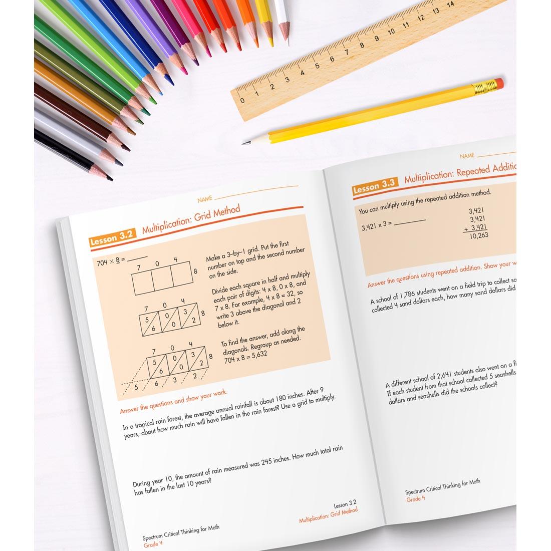 open book of Spectrum Critical Thinking For Math Grade 4 along with colored pencils, a ruler and a pencil