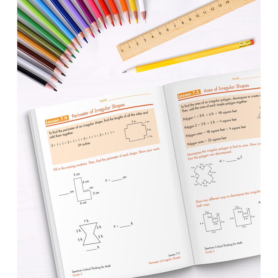 open book of Spectrum Critical Thinking For Math Grade 5 along with colored pencils, a ruler and a pencil