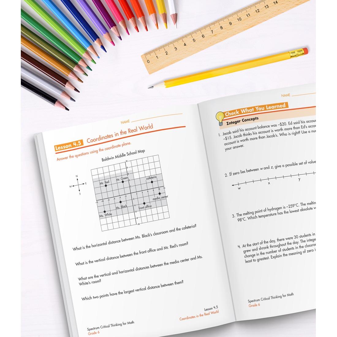 open book of Spectrum Critical Thinking For Math Grade 6 along with colored pencils, a ruler and a pencil