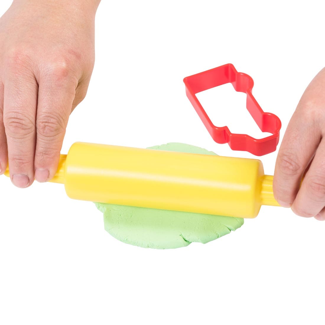 hands using the Ready 2 Learn Dough Roller with one of the Dough Cutters nearby
