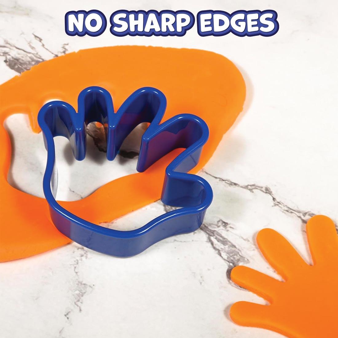 hand-shaped Dough Cutter by Ready 2 Learn over orange dough plus the text No Sharp Edges