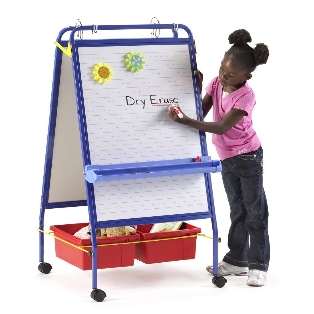 Child writing on whiteboard of the Early Learning Station