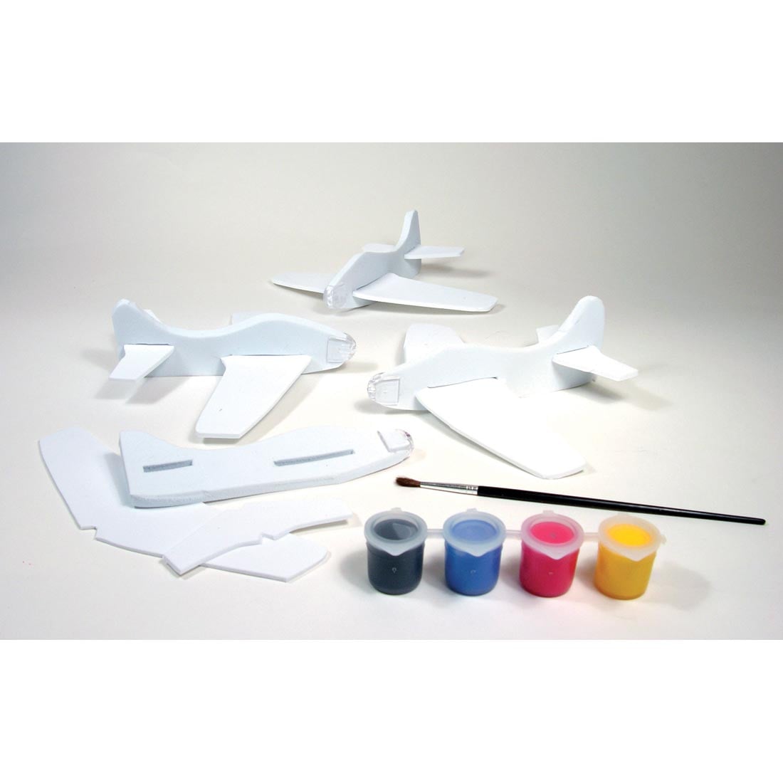 Contents of Foam Fliers Craft Kit by Creativity For Kids, showing 4 flyers, 4 paint bots and paintbrush
