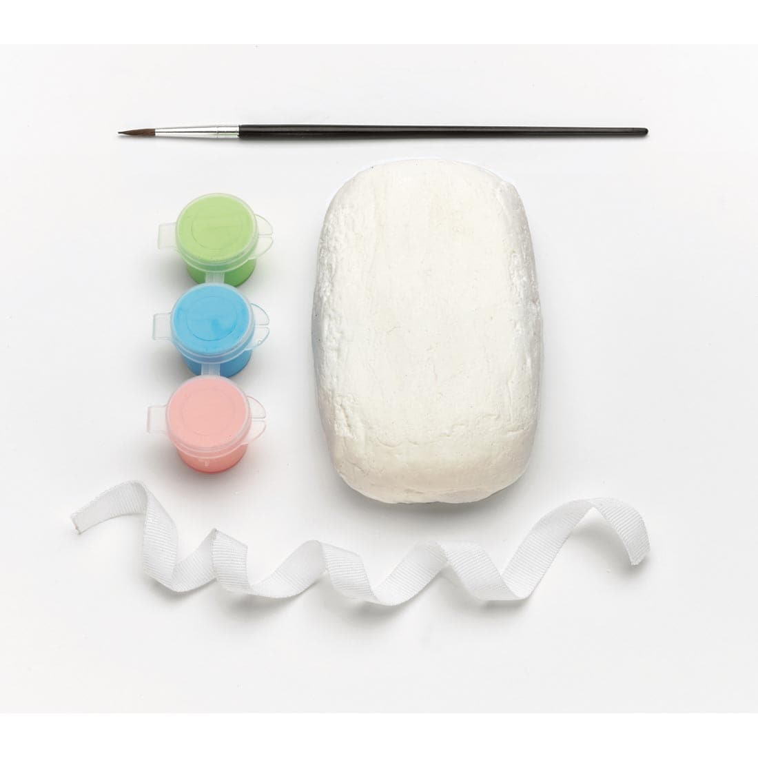 Contents of My Hand Print Craft Kit by Creativity For Kids, showing air-dry clay, 3 paint pots, brush and hanging ribbon