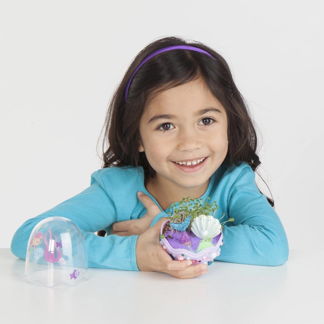 Child holding a Completed Mermaid Mini Garden By Creativity For Kids