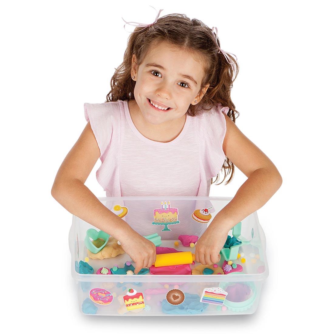 child playing with the Bake Shop Sensory Bin By Creativity For Kids