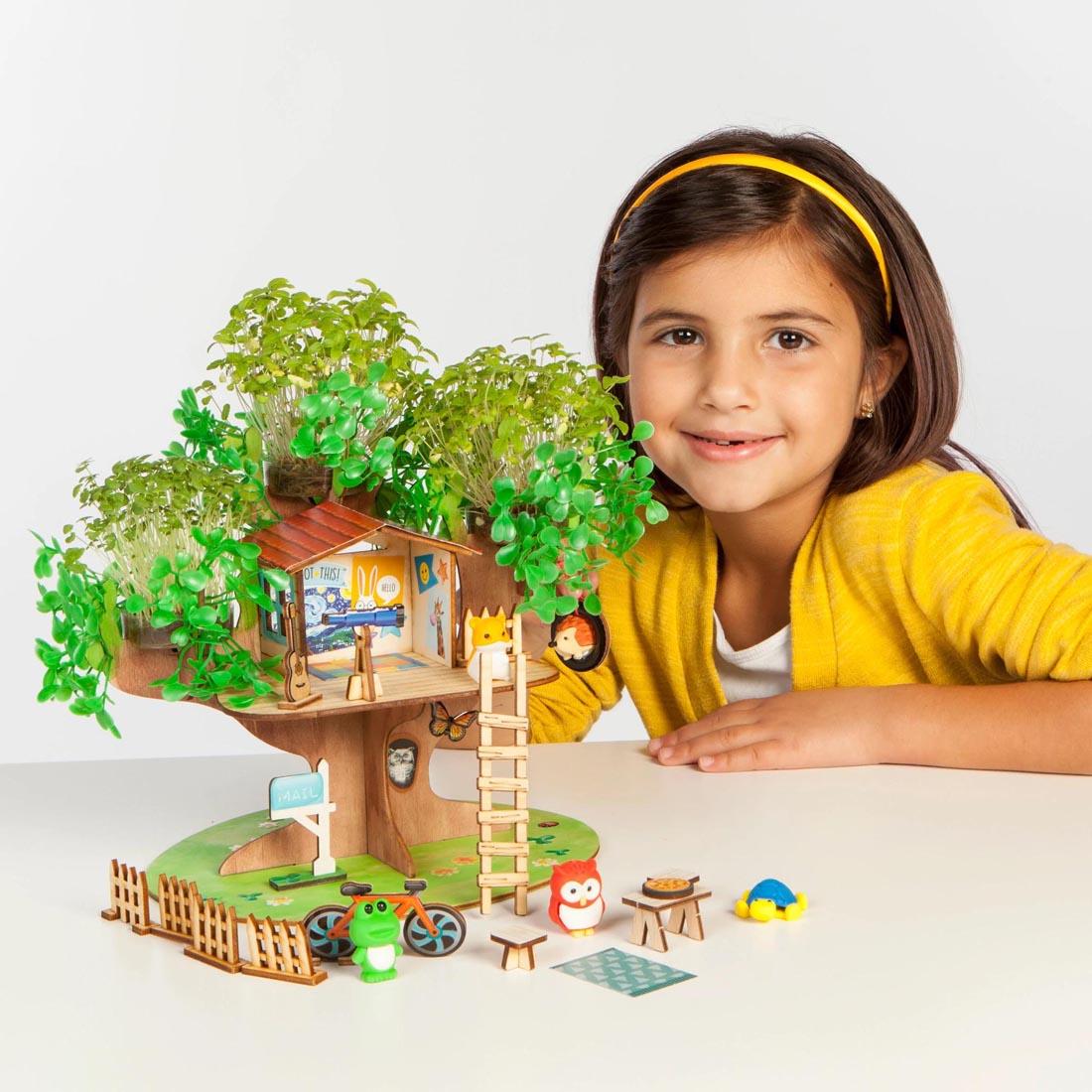 Child with completed Build & Grow Tree House By Creativity For Kids