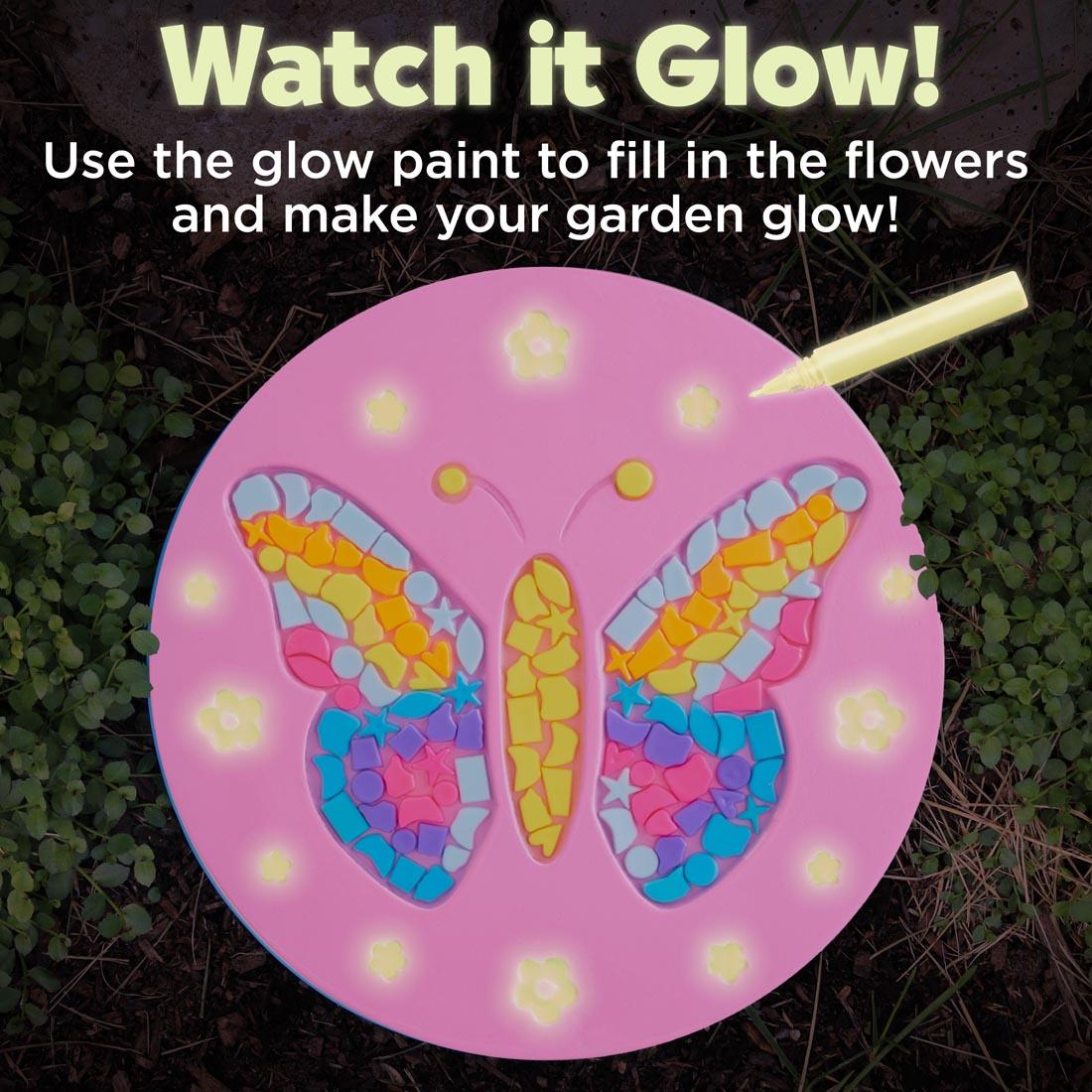 completed example of a Butterfly Garden Stone and the text Watch it Glow! Use the glow paint to fill in the flowers and make your garden glow!