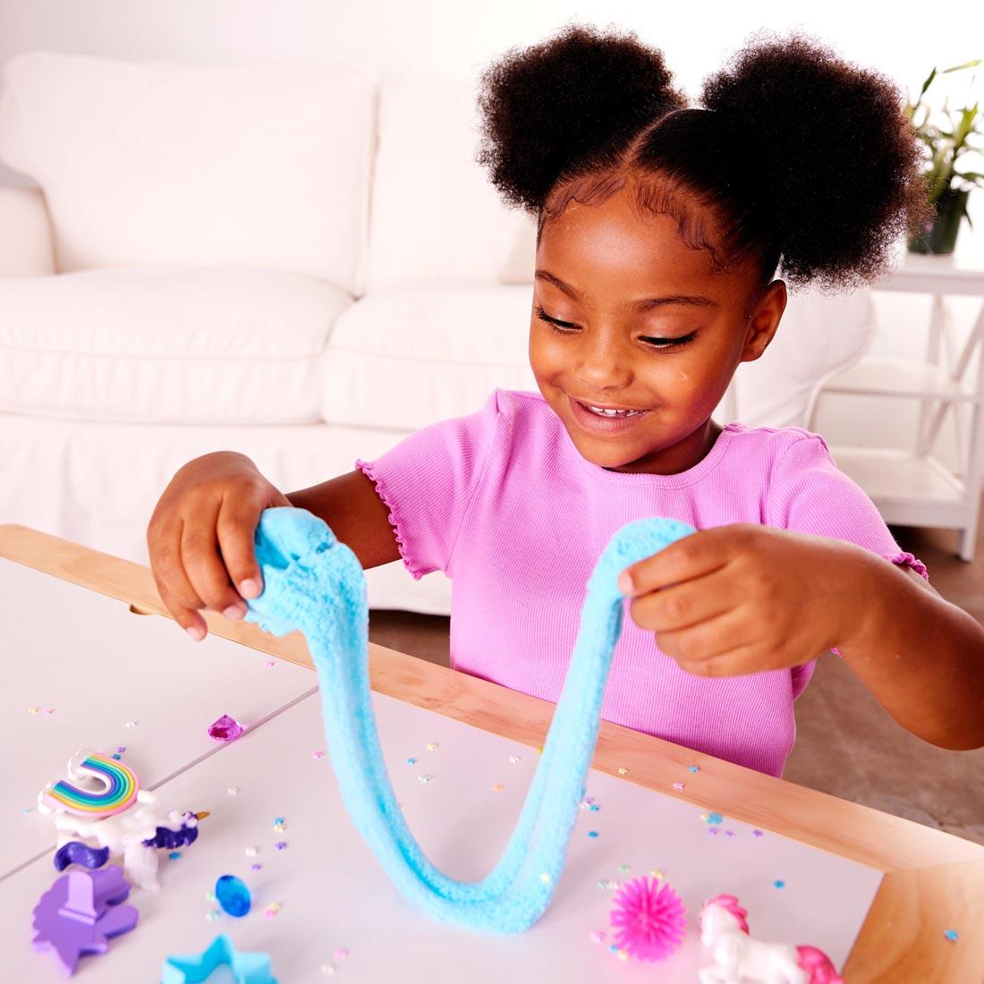 child playing with clay from the Unicorn Sensory Pack By Creativity For Kids