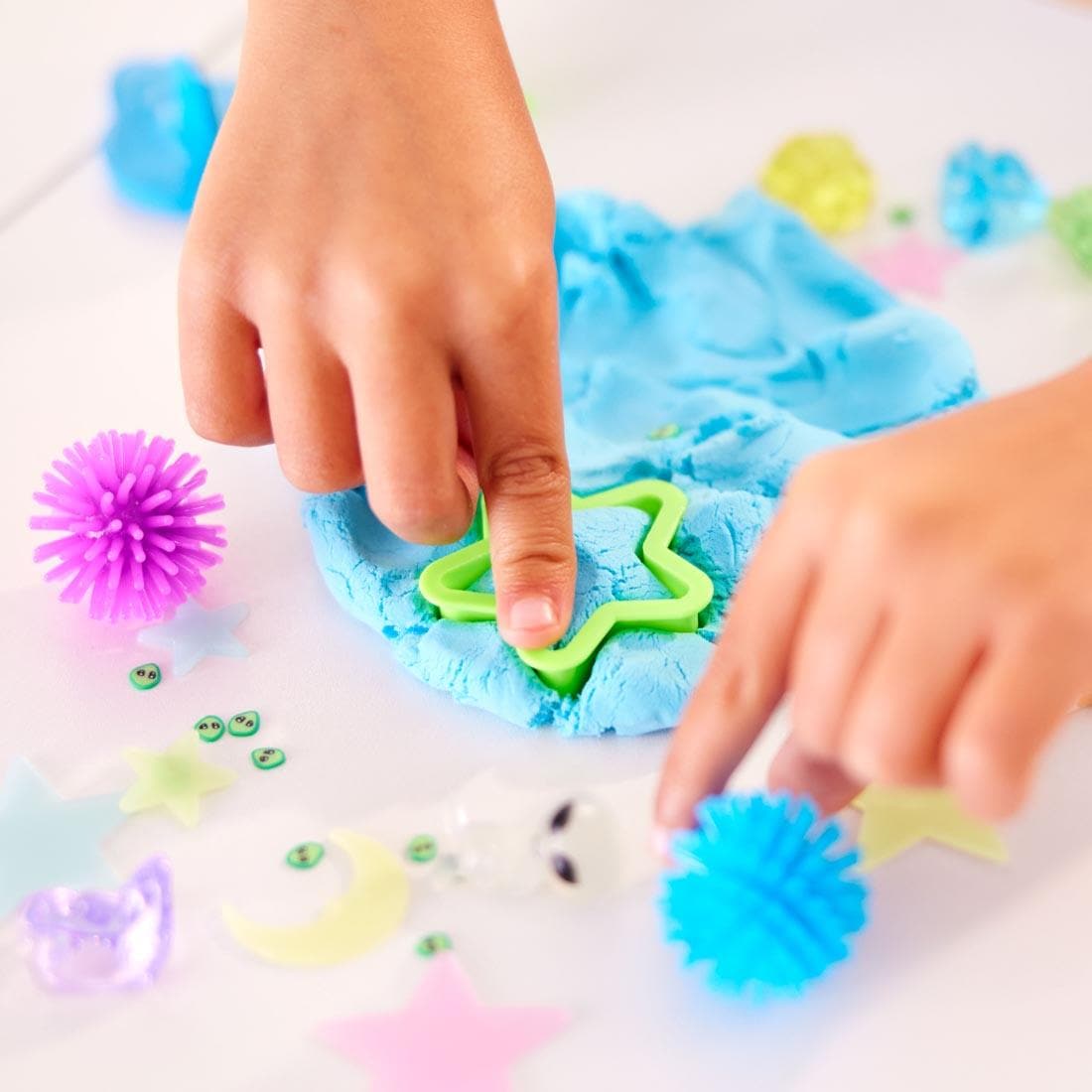 child's hands using items from the Outer Space Sensory Pack By Creativity For Kids